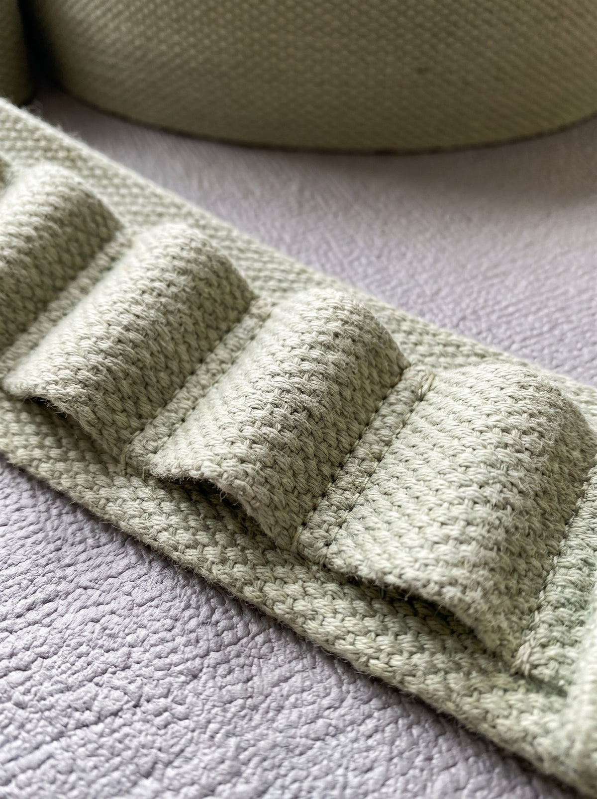 Close-up of the sewn loops and box stitching on the stretching strap