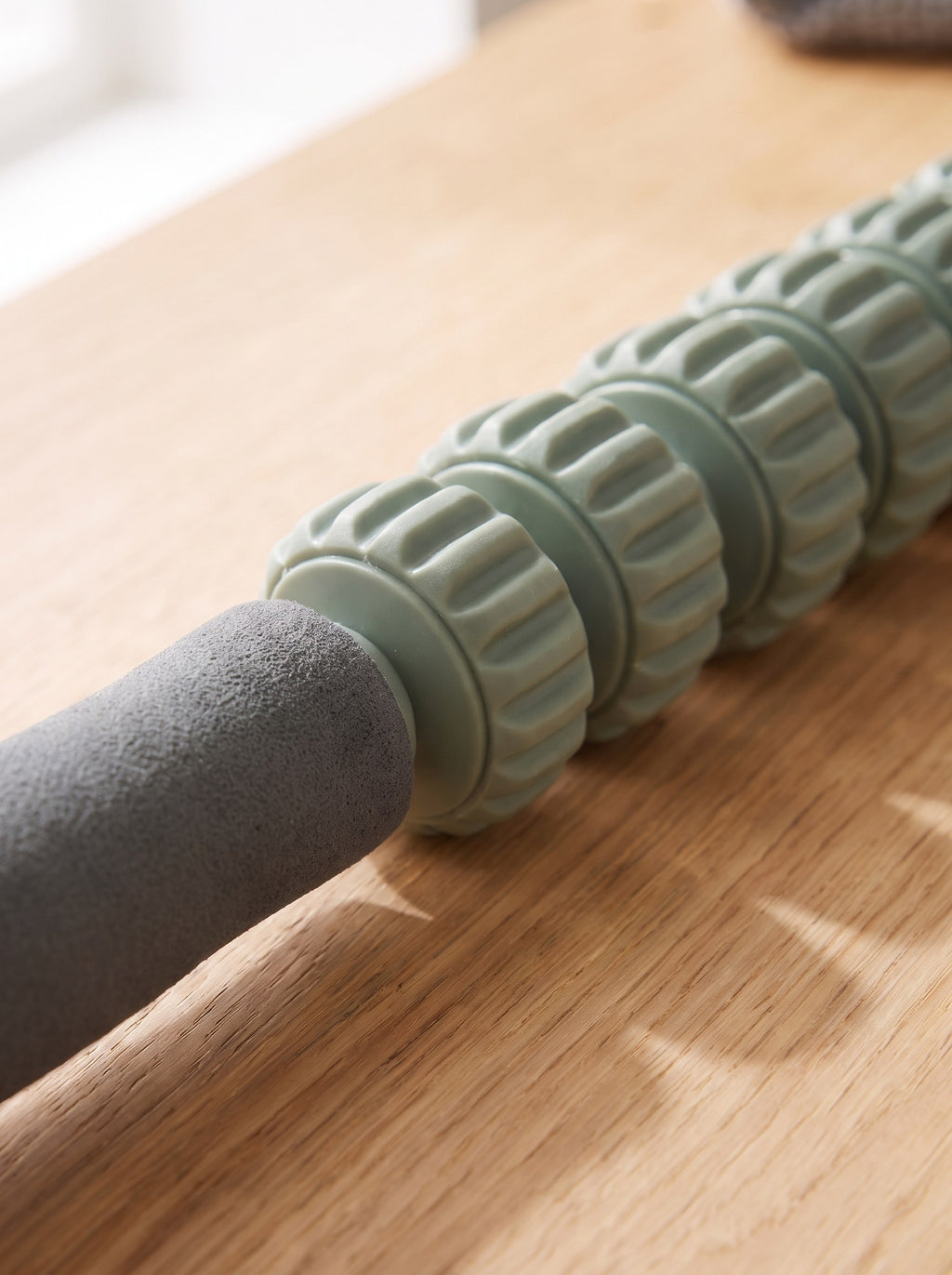 Close-up of the ridged sage rollers and graphite foam handle