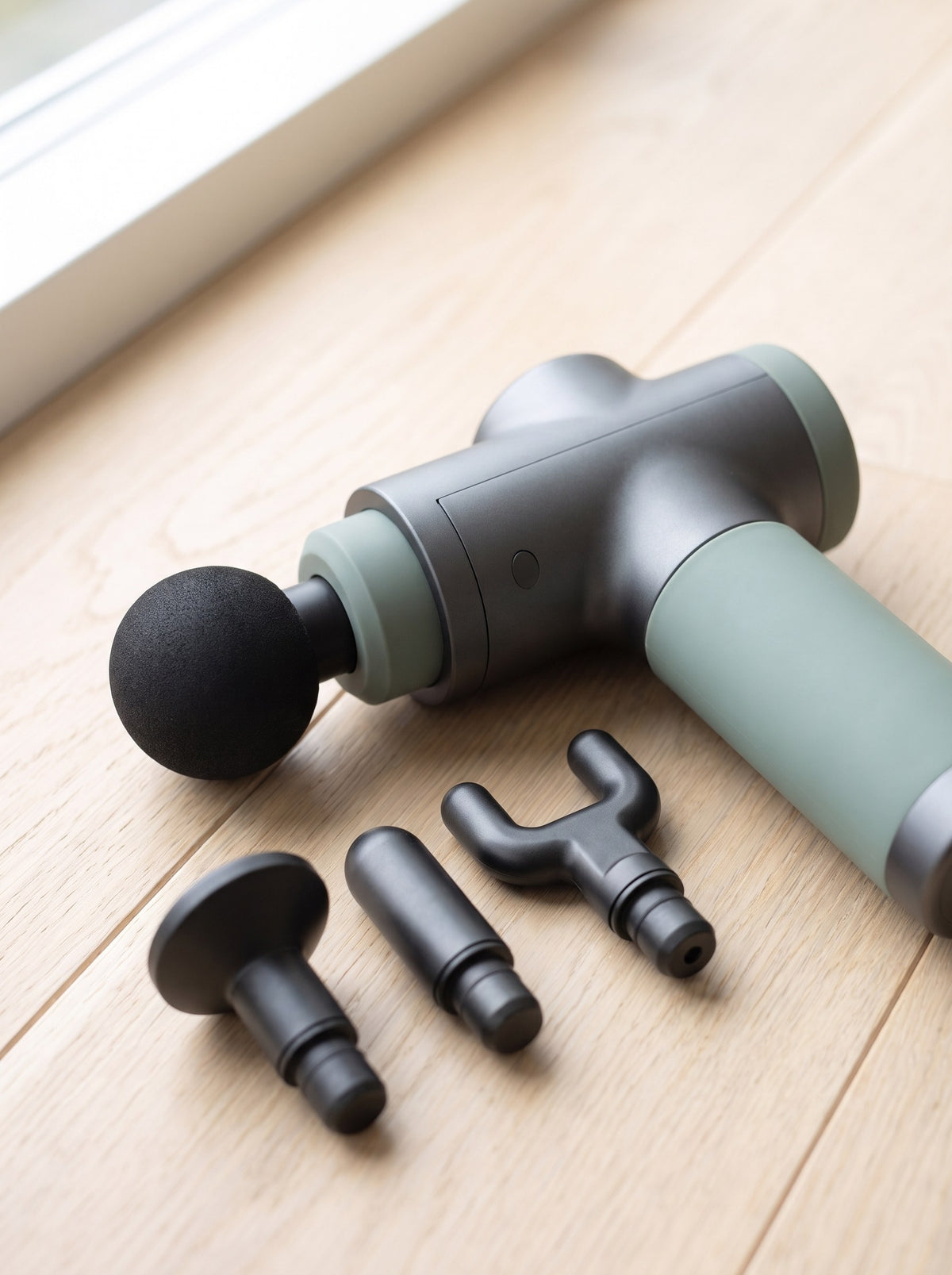 Close-up of the Pulse Mini Massage Gun grip and four interchangeable heads